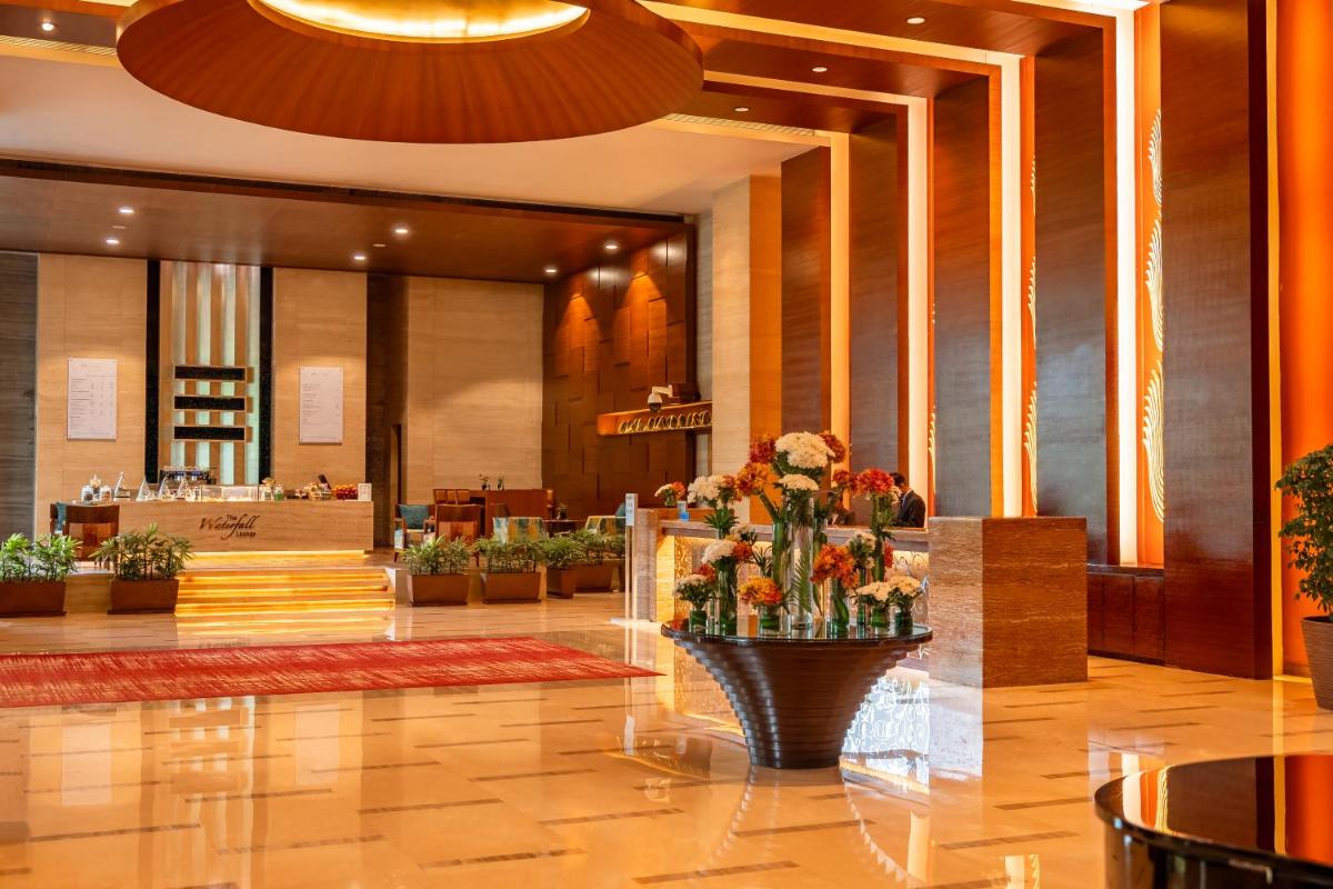 a lobby of a hotel with a vase of flowers at Hyatt Pune in Pune