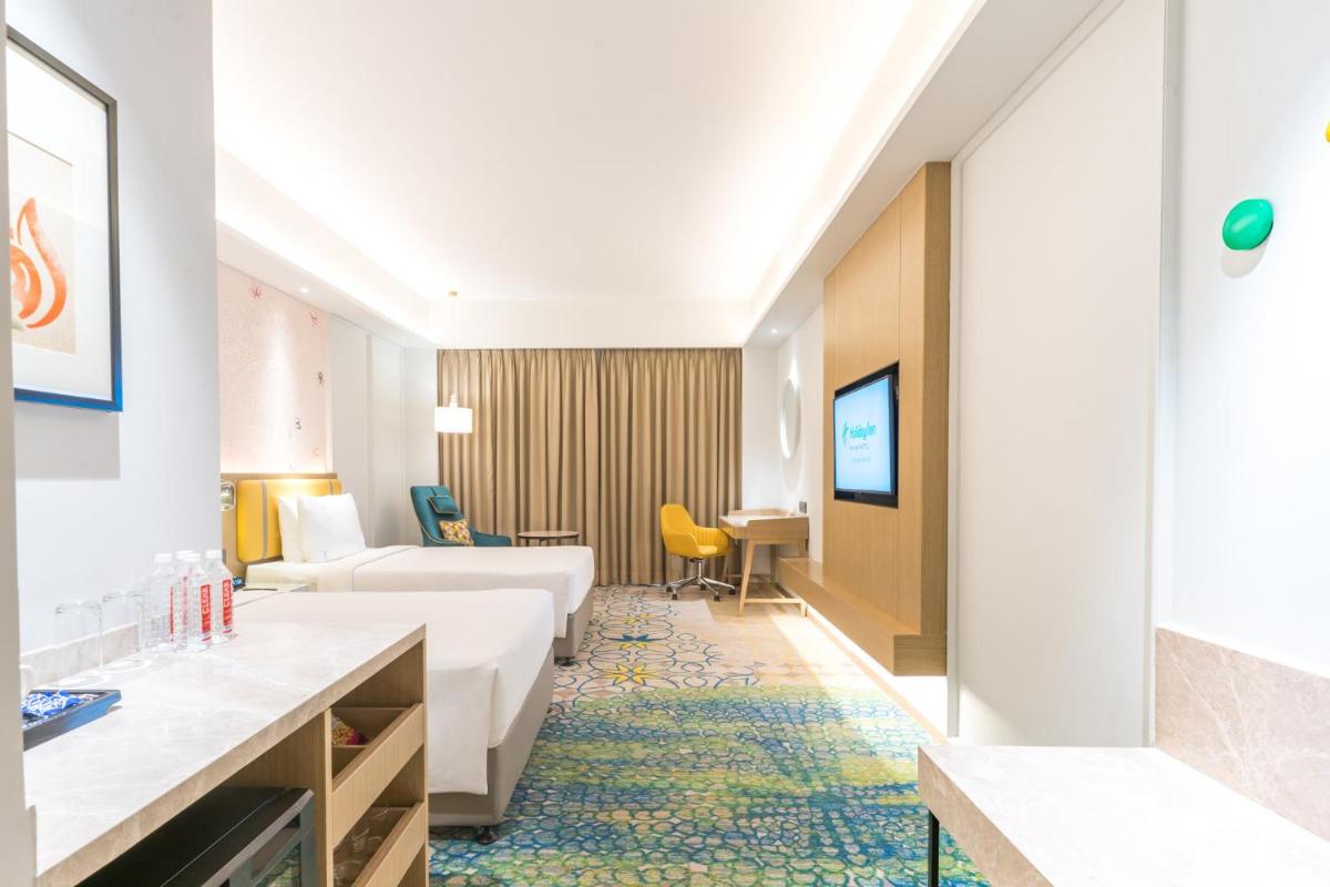 a hotel room with a couch and a table at Holiday Inn Lucknow Airport by IHG in Lucknow