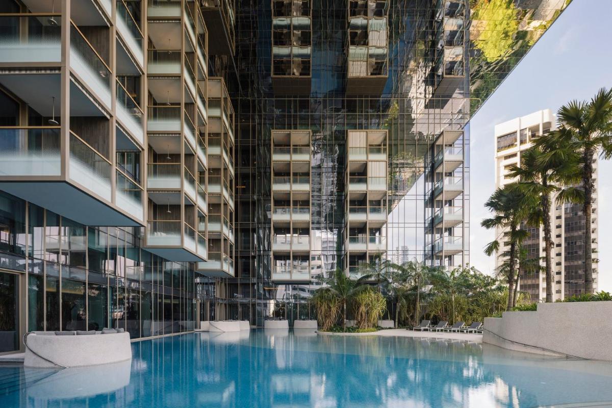 a swimming pool in front of a tall building at Pan Pacific Orchard in Singapore