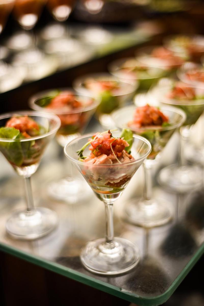a row of wine glasses filled with food on a table at Holiday Inn New Delhi Aerocity by IHG in New Delhi
