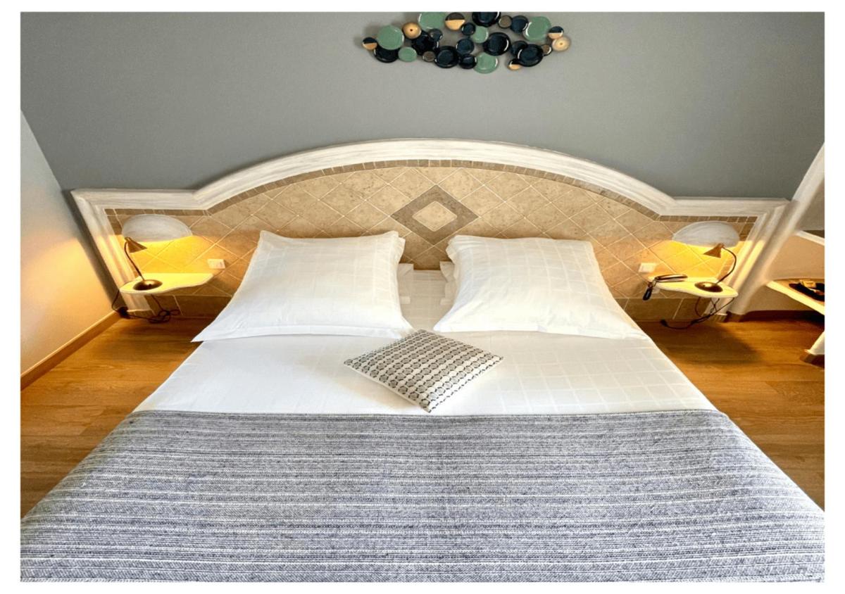 Un ou plusieurs lits dans un hébergement de l'établissement Ostella Spa & Resort