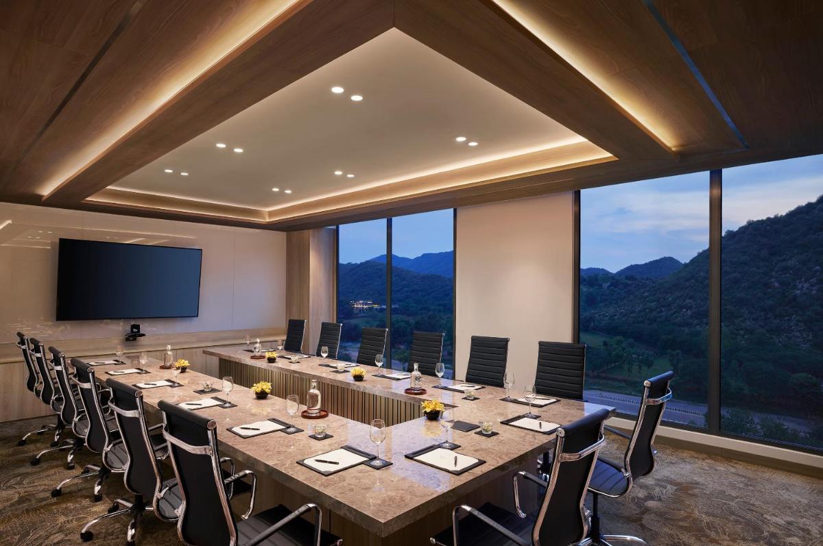 a large conference room with a long table and chairs at Taj Amer, Jaipur in Jaipur