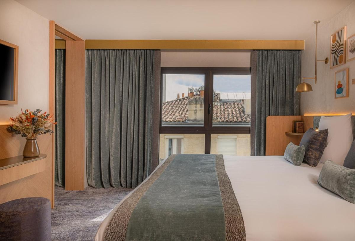 Un ou plusieurs lits dans un hébergement de l'établissement Hôtel Burdigala by Inwood Hotels