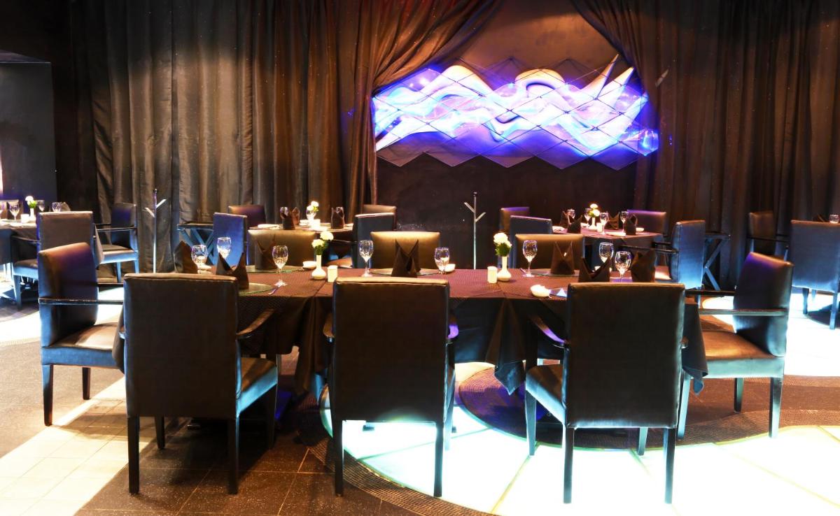 a dining room with a long table and chairs at The Ashok, New Delhi in New Delhi a dining room with a long table and chairs at The Ashok, New Delhi in New Delhi