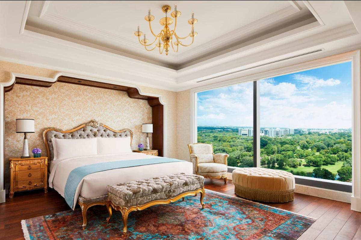 a bedroom with a bed and a large window at The Ritz-Carlton, Pune in Pune