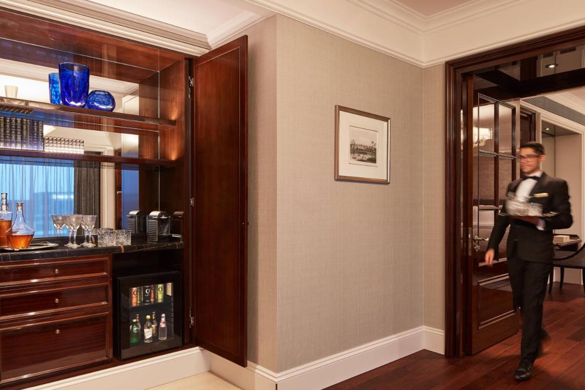a man standing in a room with a bar at The Ritz-Carlton, Pune in Pune