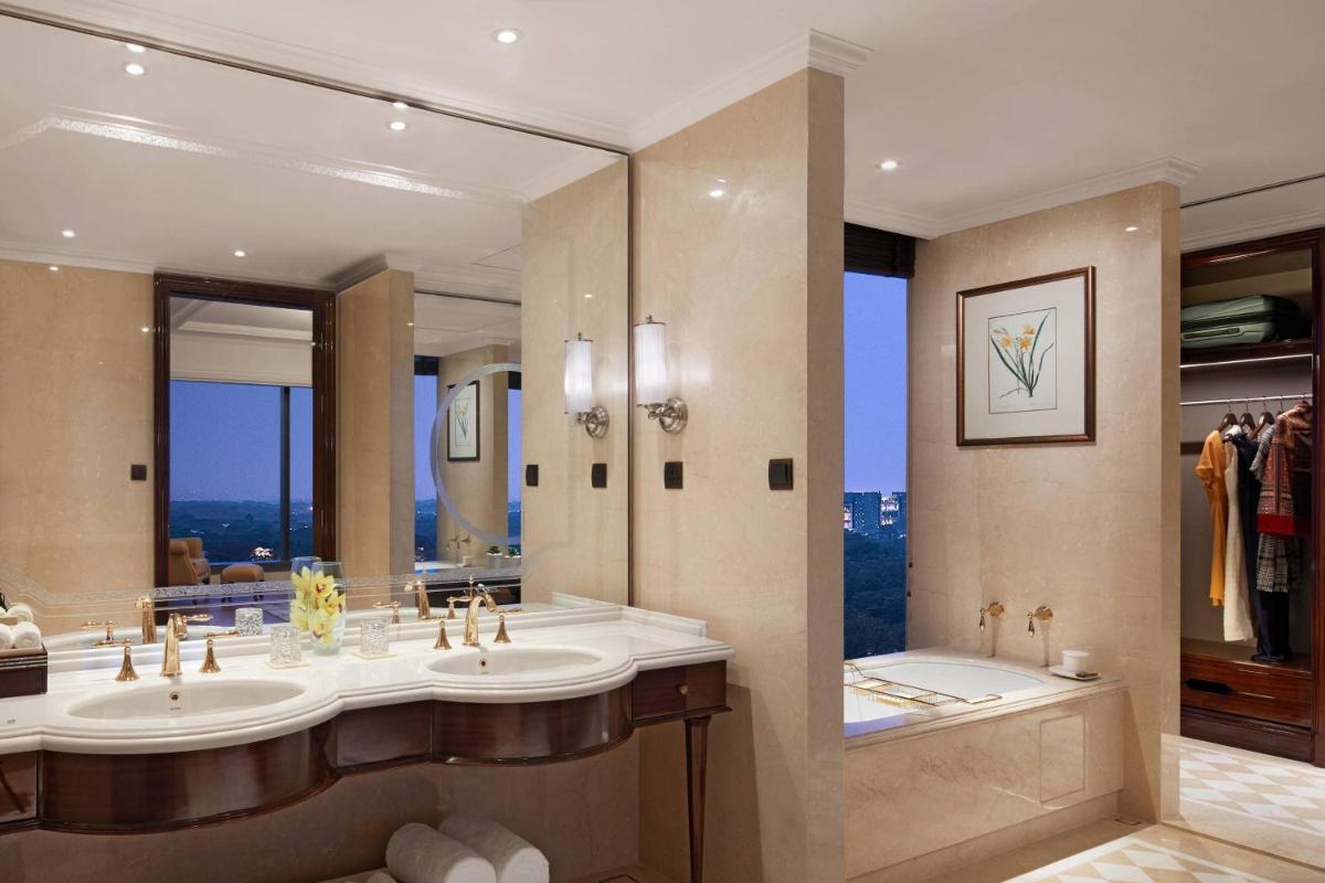 a bathroom with two sinks and a large mirror at The Ritz-Carlton, Pune in Pune
