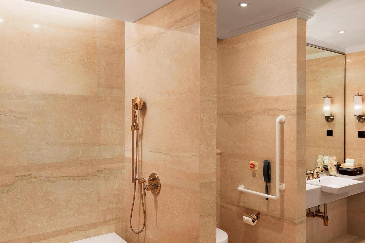 a bathroom with a shower and a sink at The Ritz-Carlton, Pune in Pune