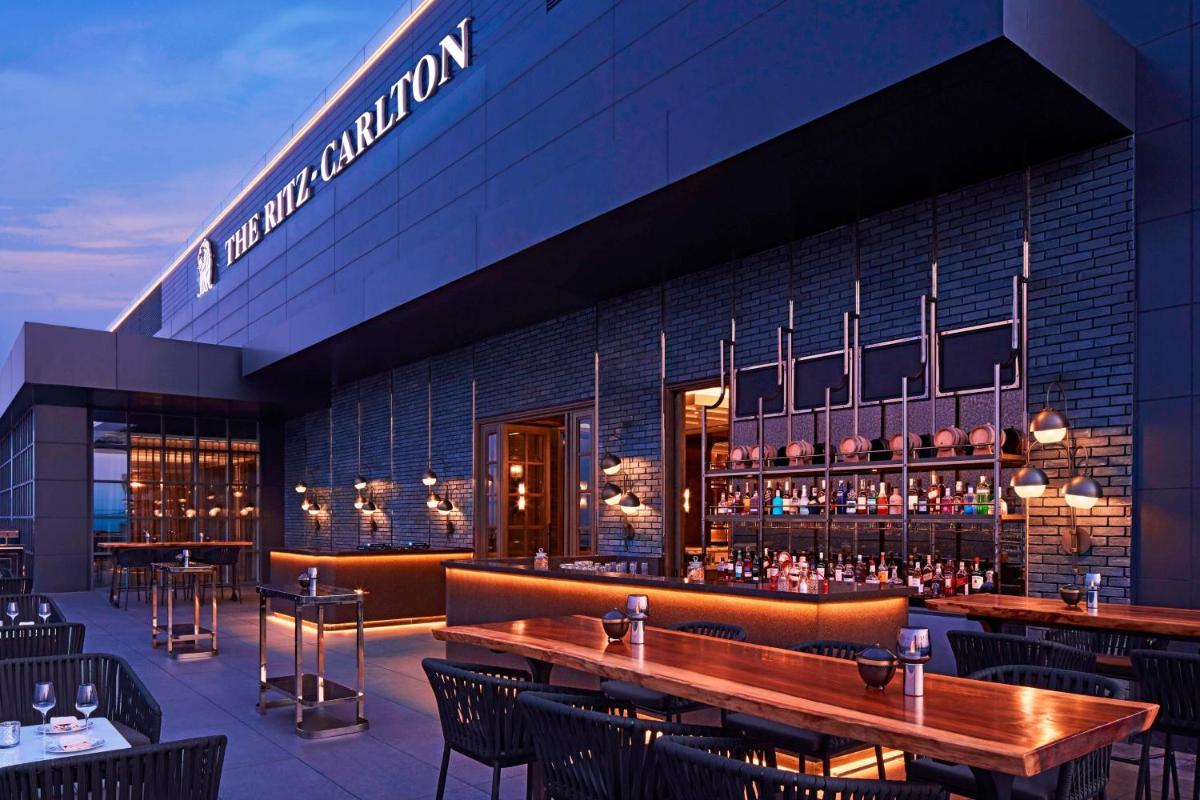 a restaurant with tables and chairs in front of a building at The Ritz-Carlton, Pune in Pune