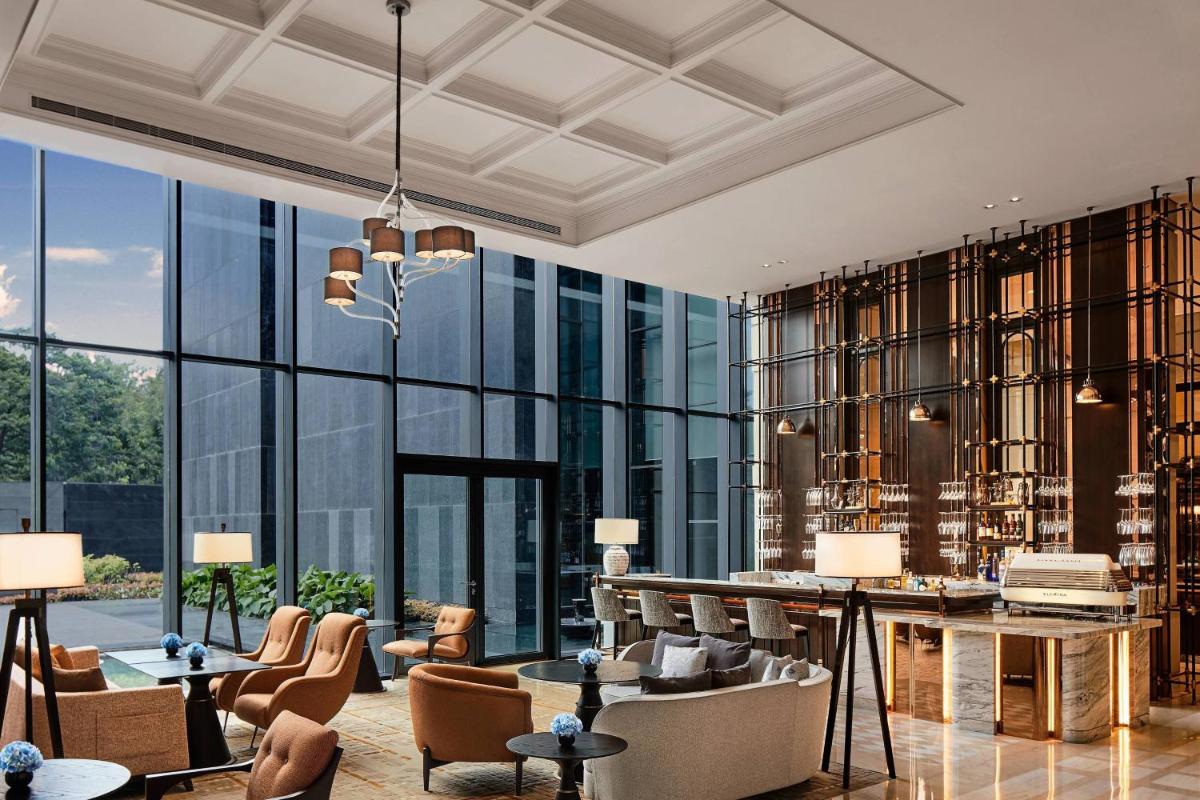 a rendering of a lobby with a large glass wall at The Ritz-Carlton, Pune in Pune