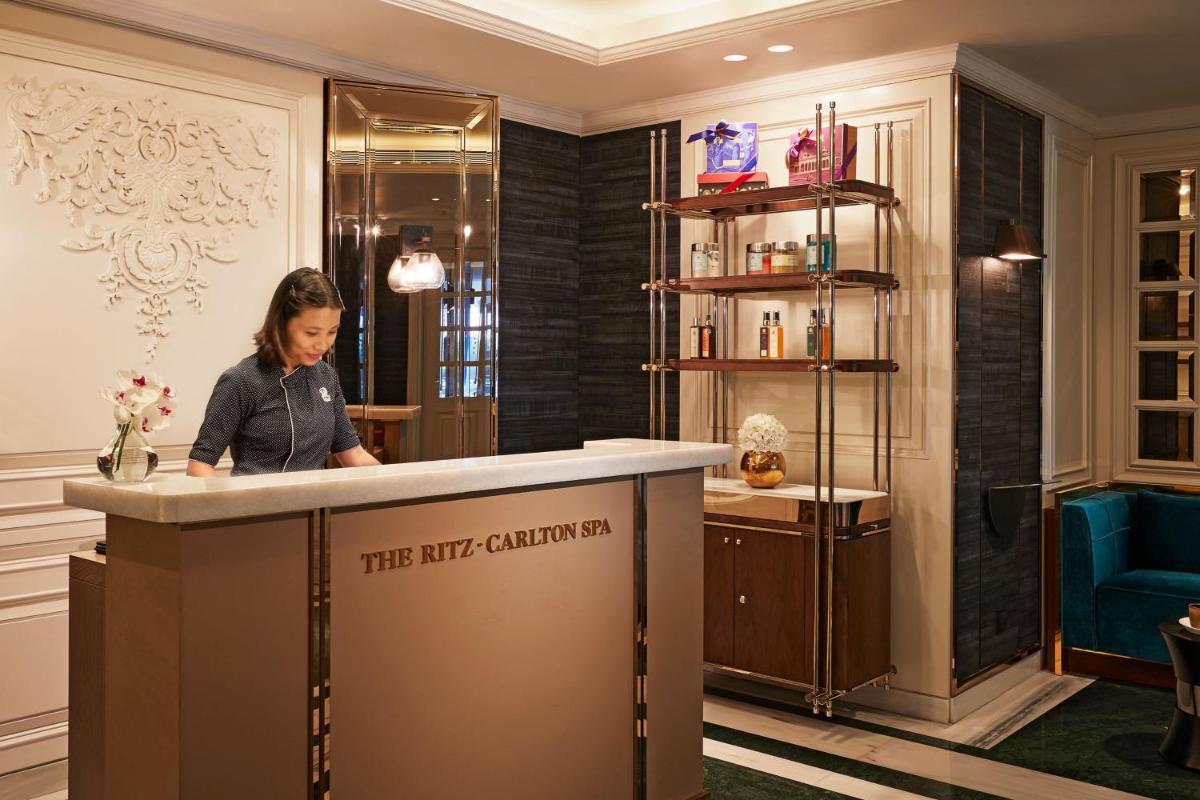 a woman standing at a counter in a dressing room at The Ritz-Carlton, Pune in Pune