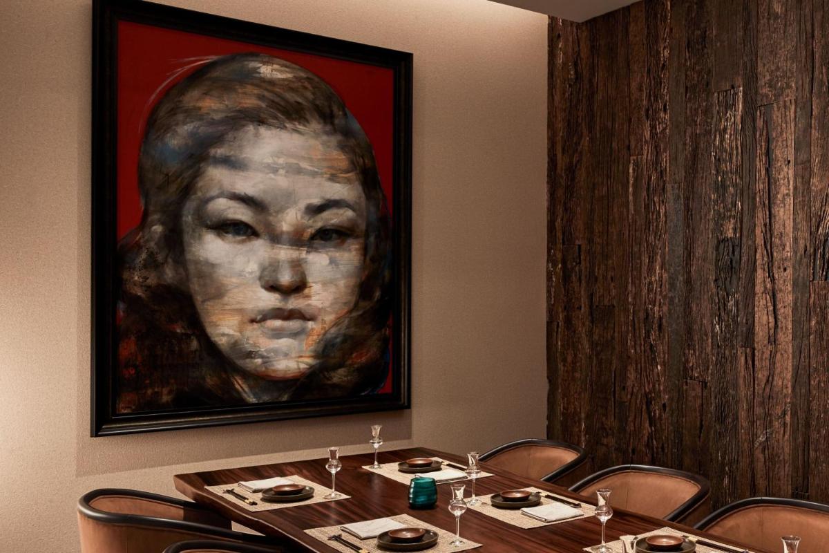 a painting of a woman on the wall of a restaurant at The Ritz-Carlton, Pune in Pune