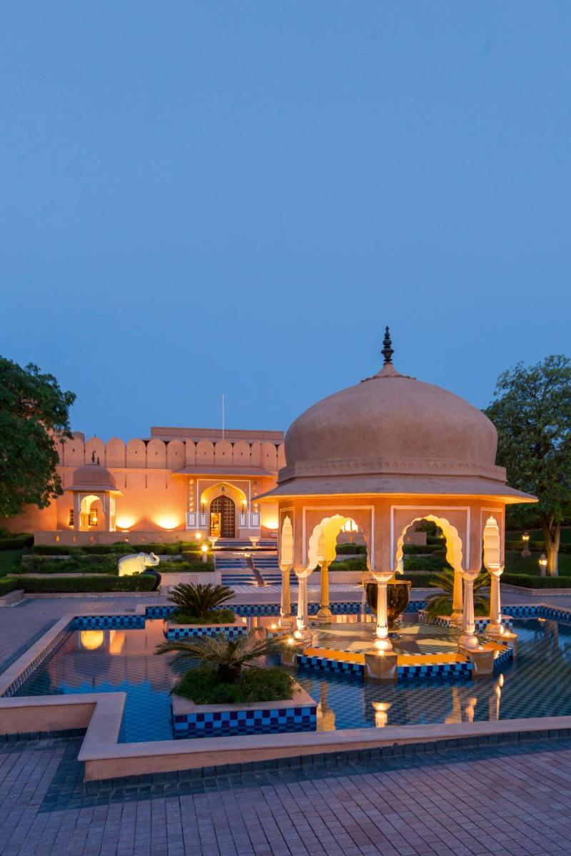 a gazebo in front of a building at night at The Oberoi Rajvilas Jaipur in Jaipur