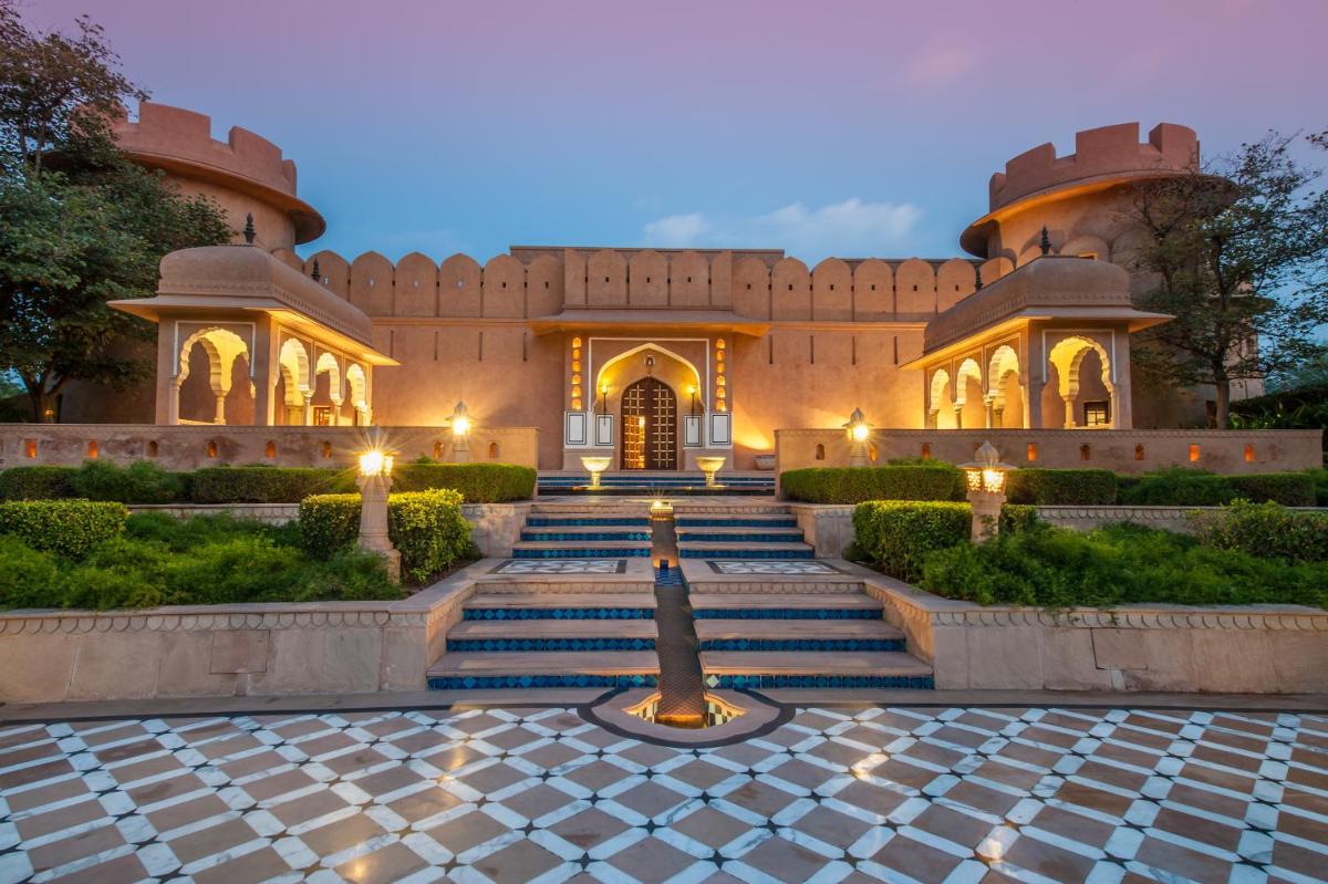 a building with stairs leading to a building with lights at The Oberoi Rajvilas Jaipur in Jaipur