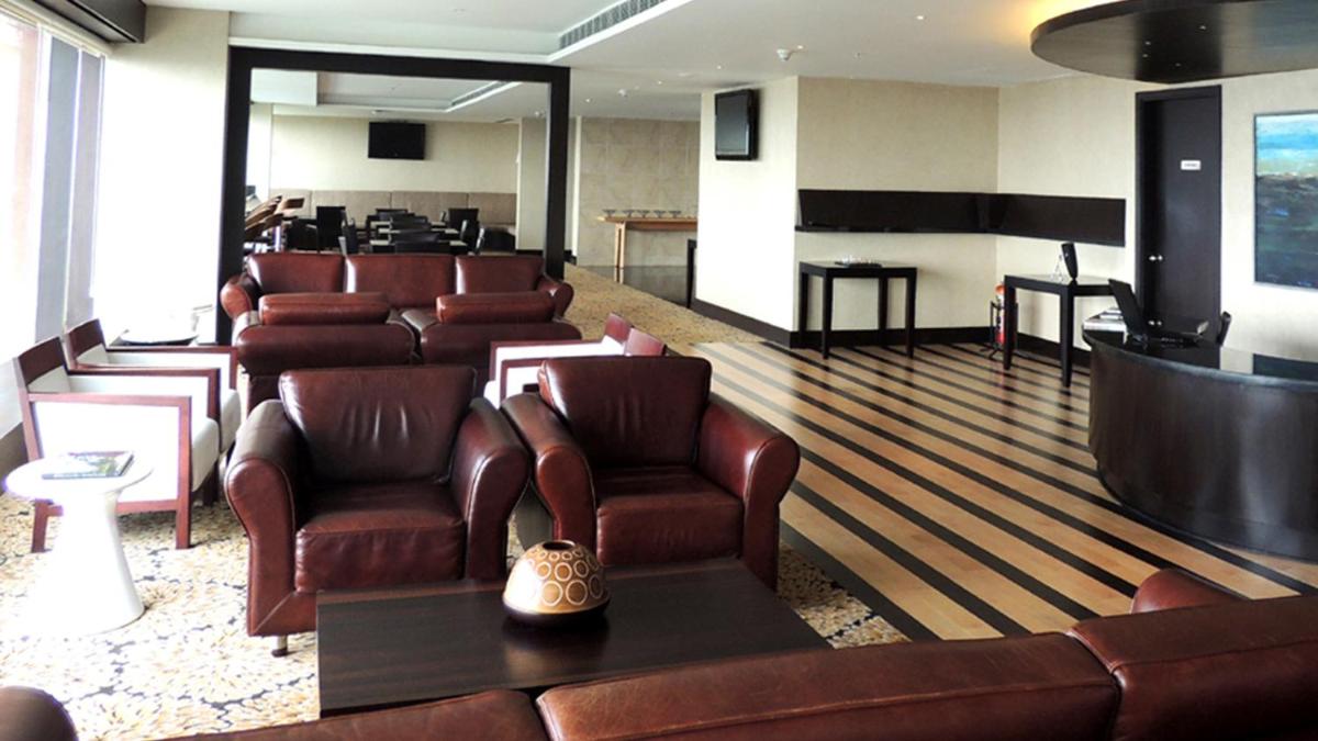 a waiting room with leather chairs and a salon at The Oterra in Bengaluru