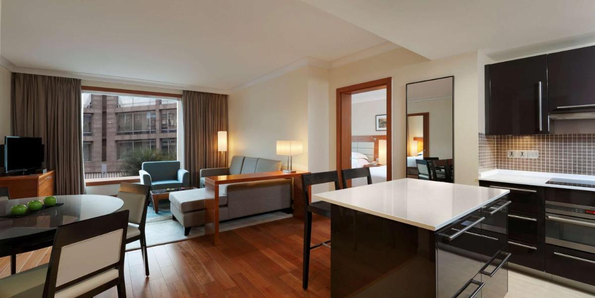 a kitchen and living room of a apartment at Hilton Bangalore Embassy GolfLinks in Bengaluru