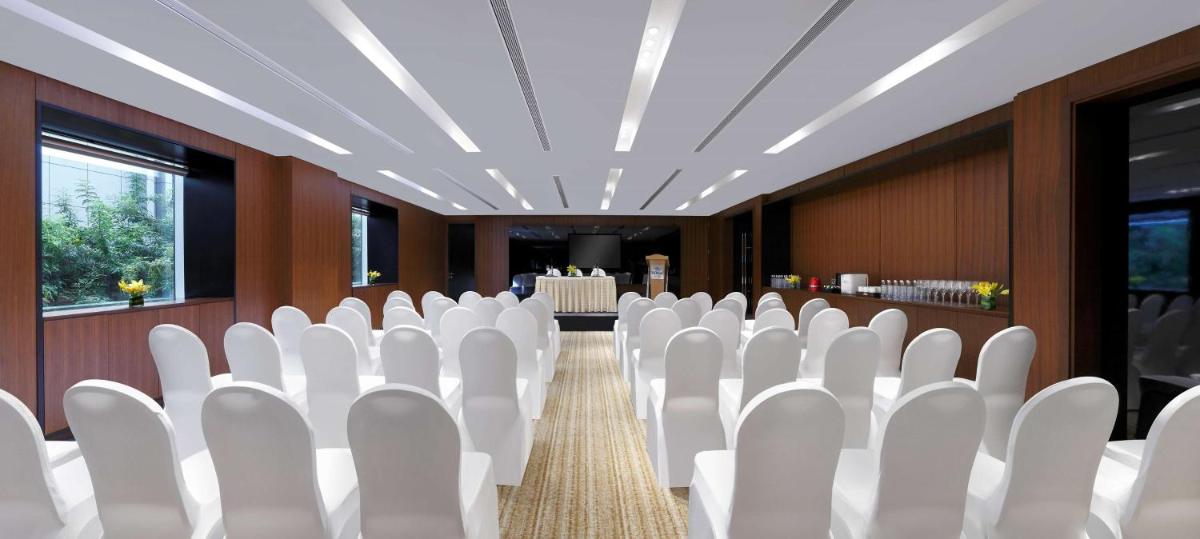 a row of white chairs in a conference room at Hilton Bangalore Embassy GolfLinks in Bengaluru