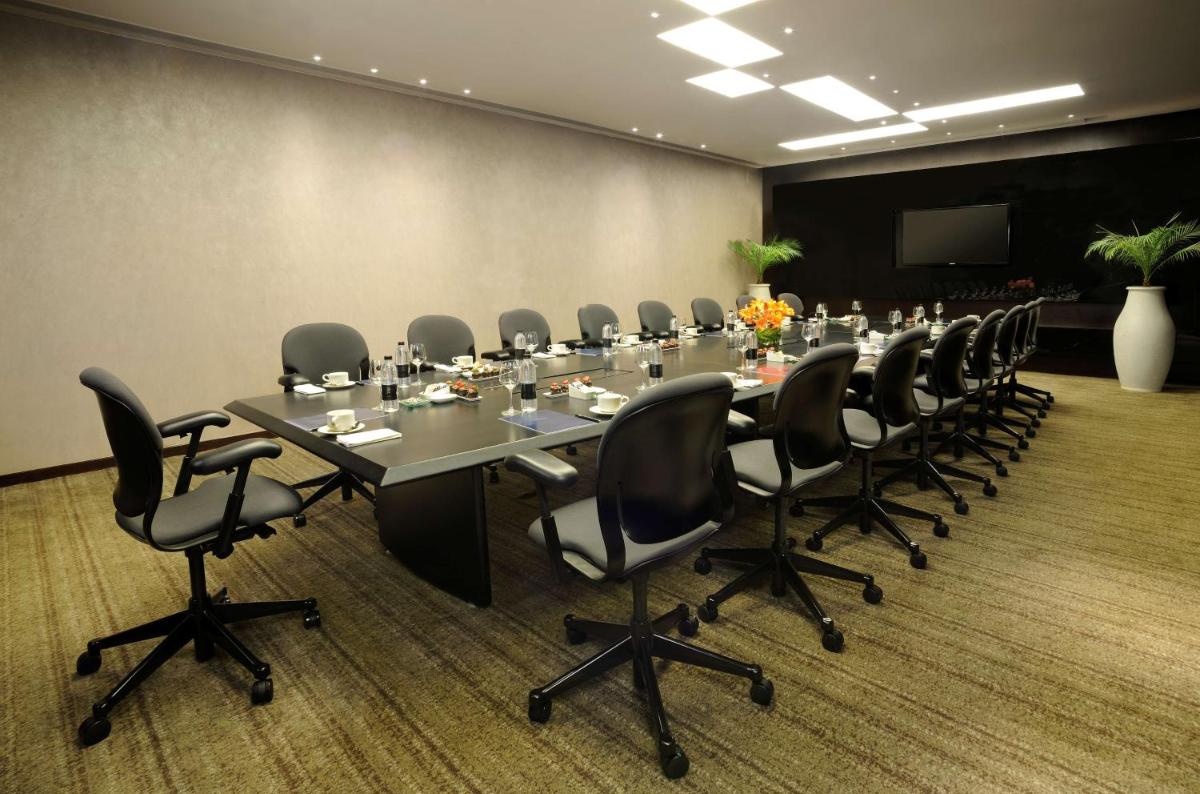 a conference room with a long table and chairs at Hilton Bangalore Embassy GolfLinks in Bengaluru