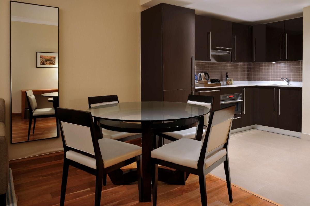 a kitchen and dining room with a table and chairs at Hilton Bangalore Embassy GolfLinks in Bengaluru