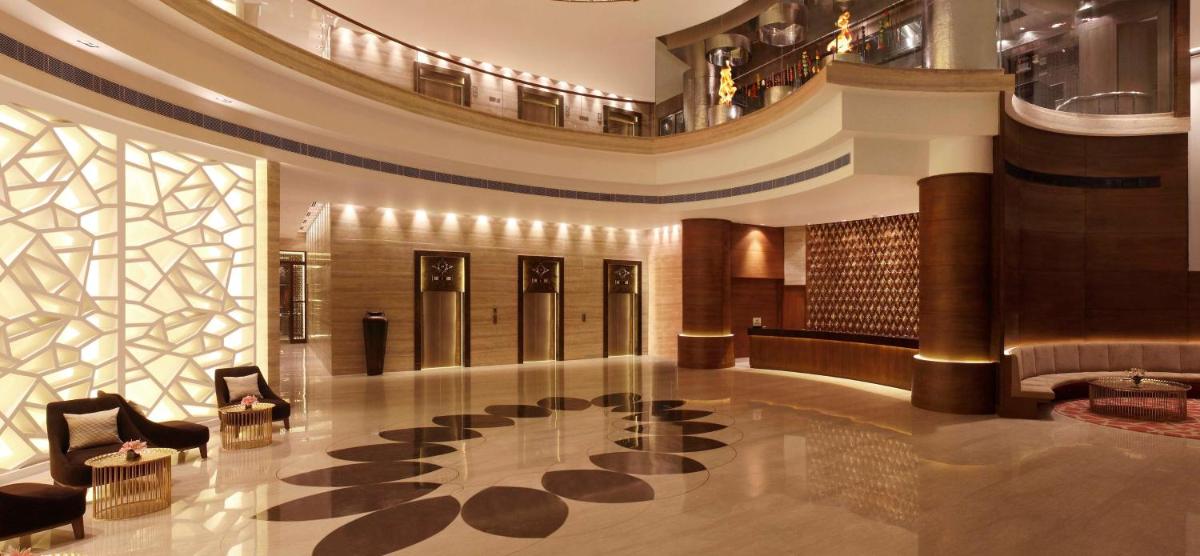 a lobby with a large building with a large lobby at Hilton Jaipur in Jaipur a lobby with a large building with a large lobby at Hilton Jaipur in Jaipur