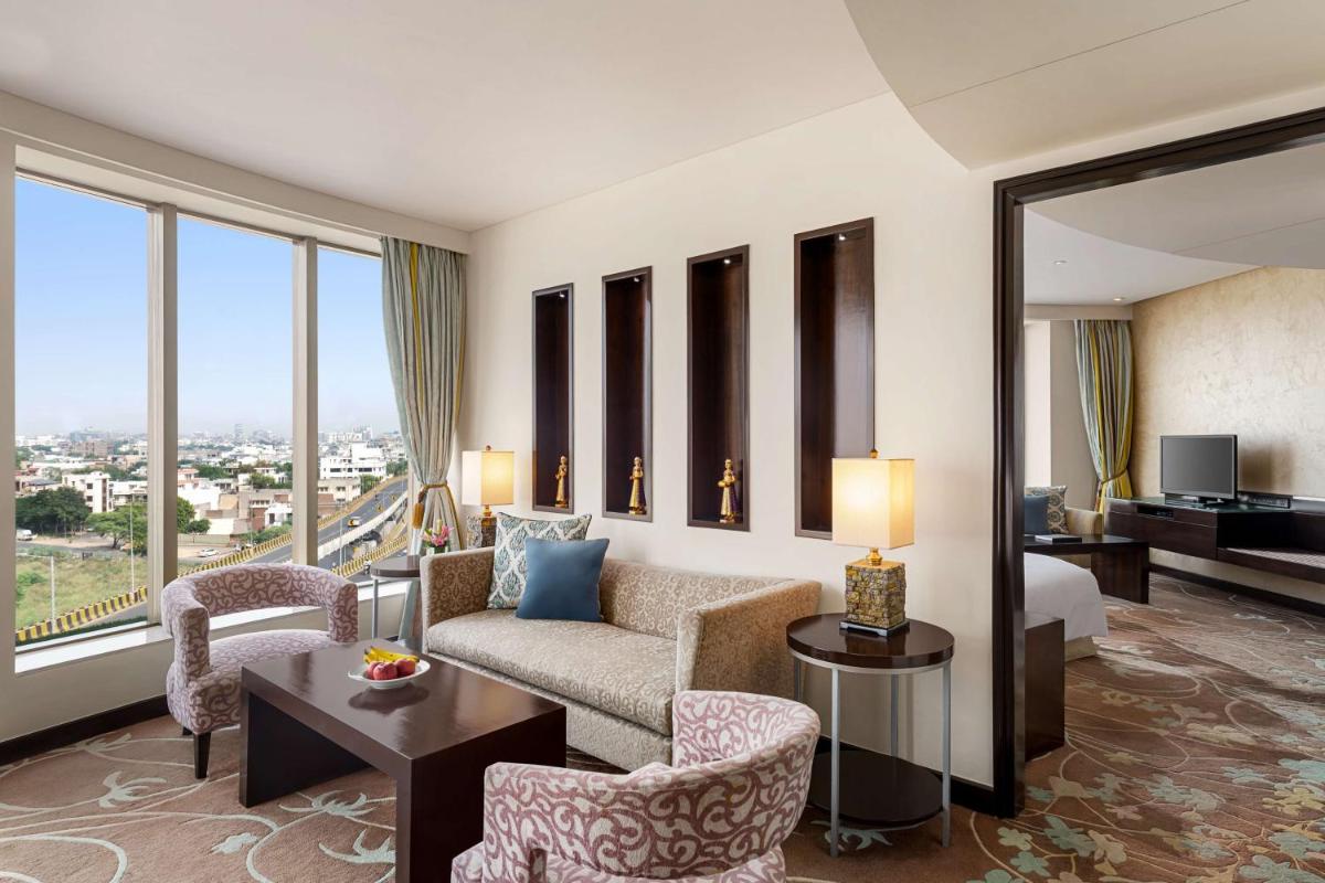 a living room with a couch and chairs at Hilton Jaipur in Jaipur a living room with a couch and chairs at Hilton Jaipur in Jaipur