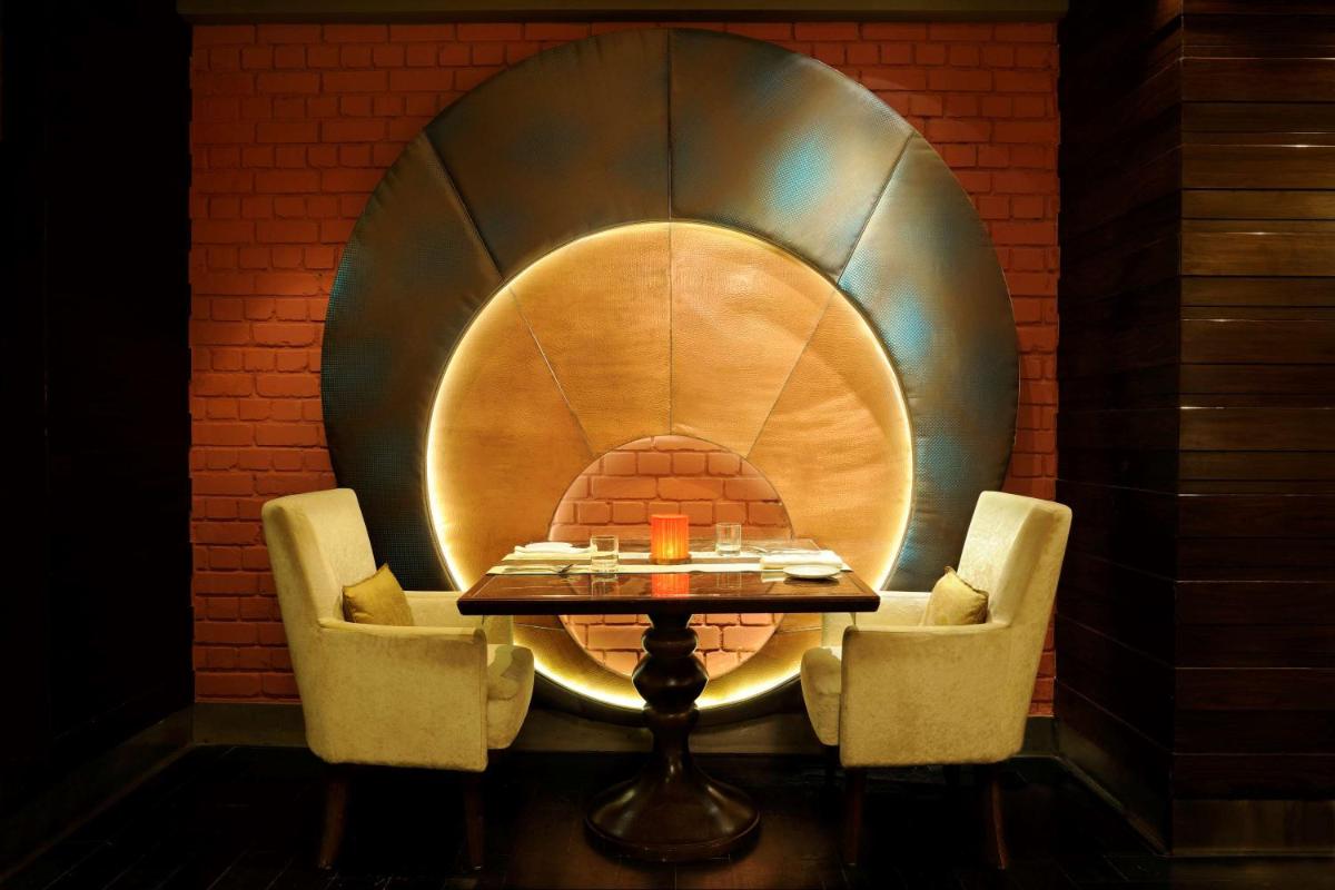a table and chairs in a room with a circle at Hilton Chennai in Chennai
