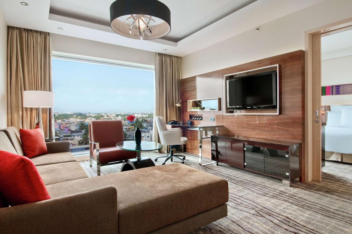 a living room with a couch and a television at Hilton Chennai in Chennai