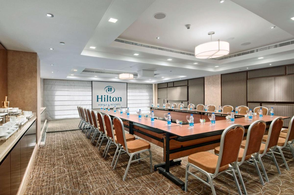a conference room with a large table and chairs at Hilton Chennai in Chennai