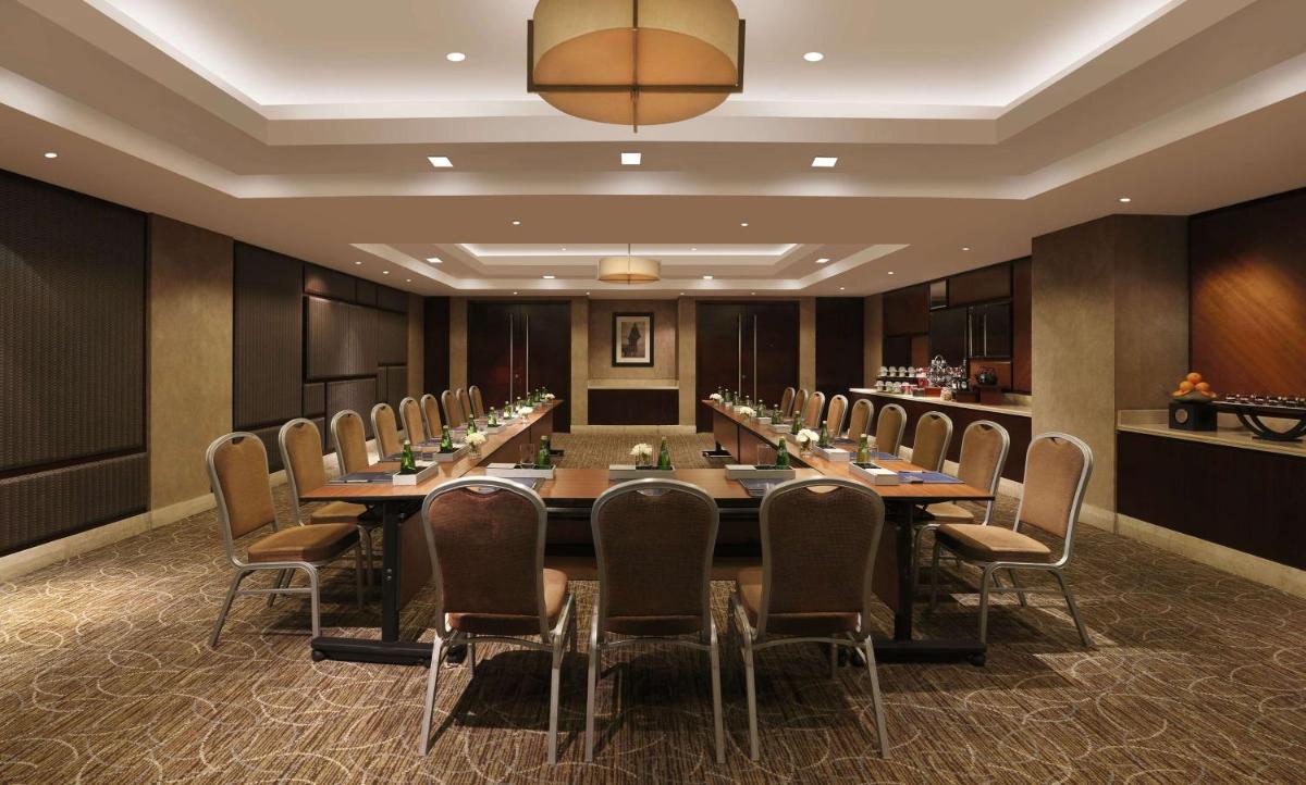 a conference room with a long table and chairs at Hilton Chennai in Chennai