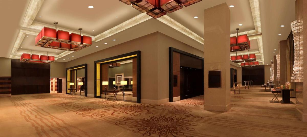 a lobby of a hotel with red chandeliers at Hilton Chennai in Chennai
