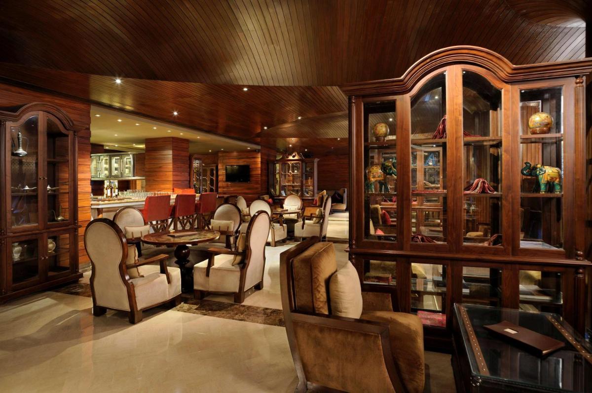 a dining room with a table and chairs at Hilton Chennai in Chennai