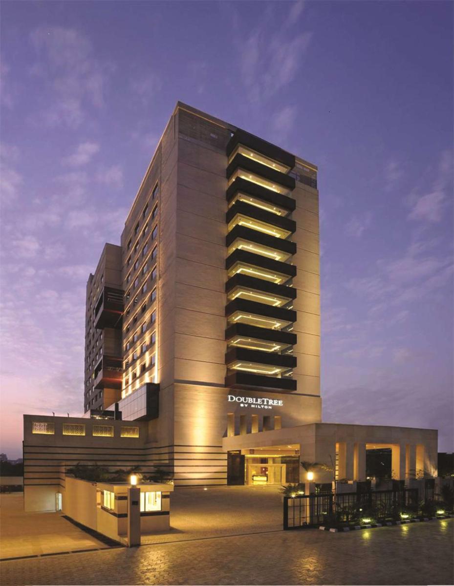 a large building with a hotel at night at DoubleTree by Hilton Gurgaon New Delhi NCR in Gurgaon a large building with a hotel at night at DoubleTree by Hilton Gurgaon New Delhi NCR in Gurgaon