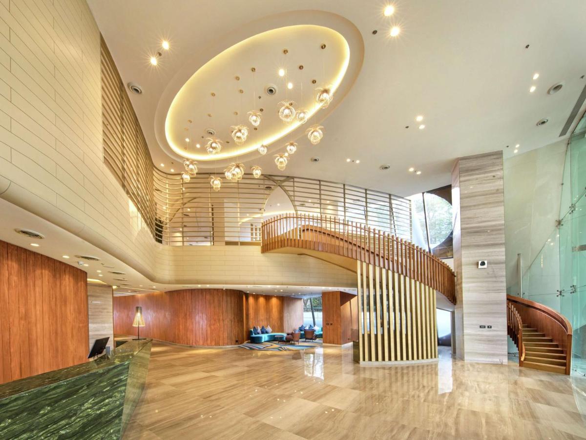a lobby with a spiral staircase in a building at DoubleTree by Hilton Ahmedabad in Ahmedabad
