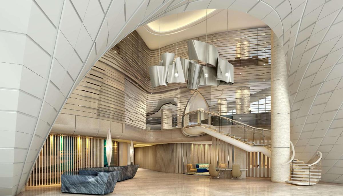 a lobby with a spiral staircase in a building at DoubleTree by Hilton Ahmedabad in Ahmedabad