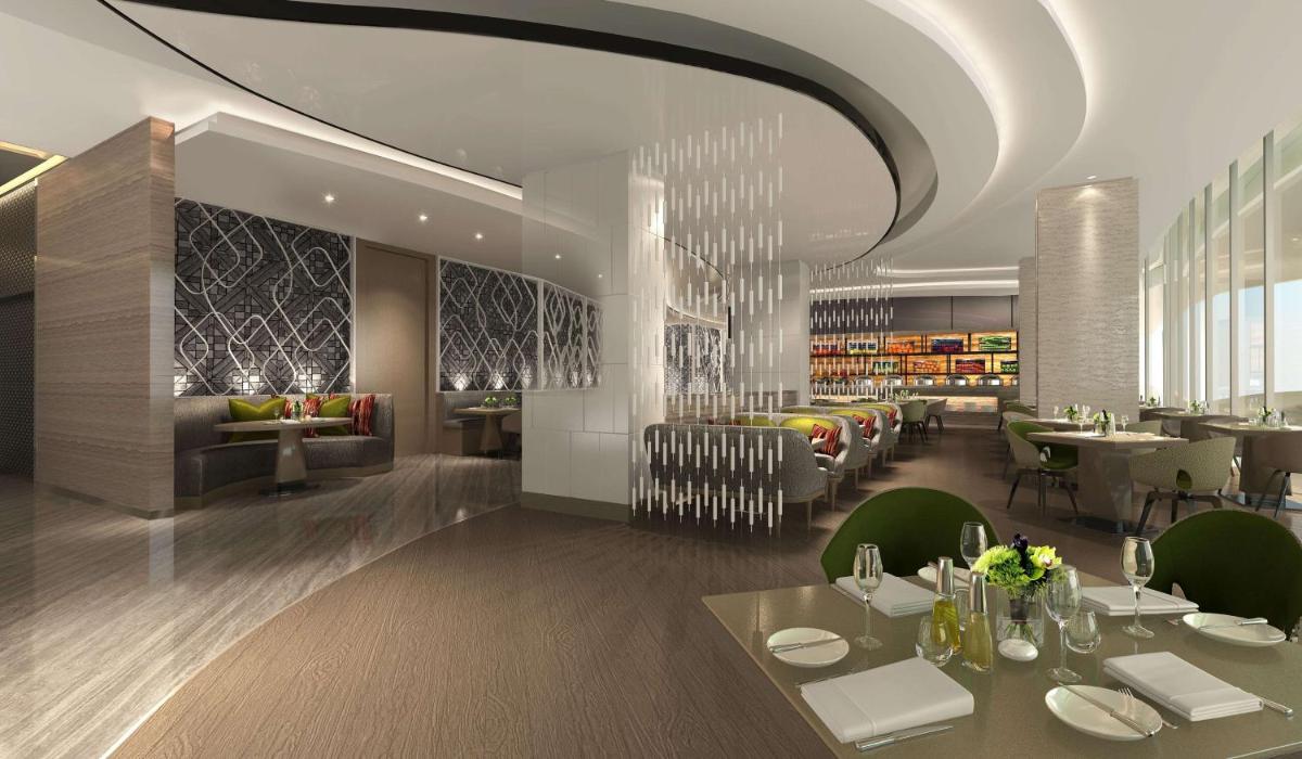 a restaurant with tables and chairs and a dining room at DoubleTree by Hilton Ahmedabad in Ahmedabad