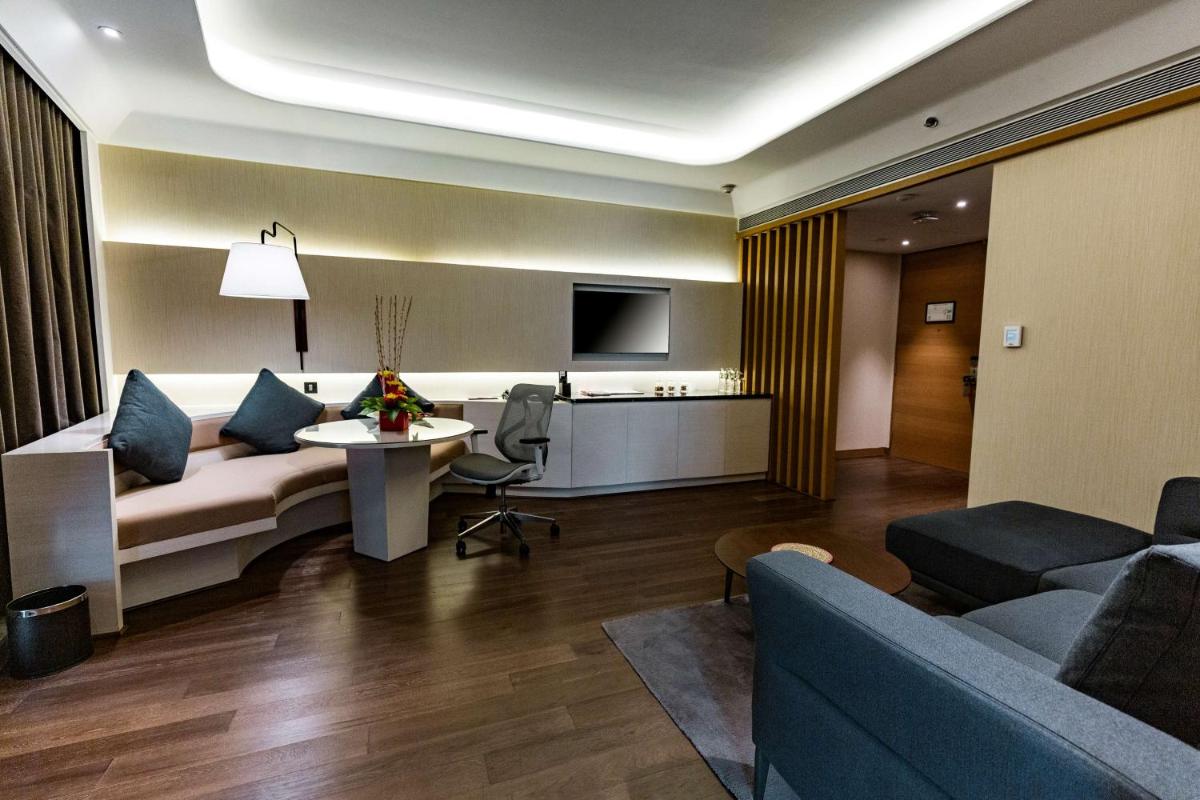a living room with a couch and a table at DoubleTree by Hilton Ahmedabad in Ahmedabad