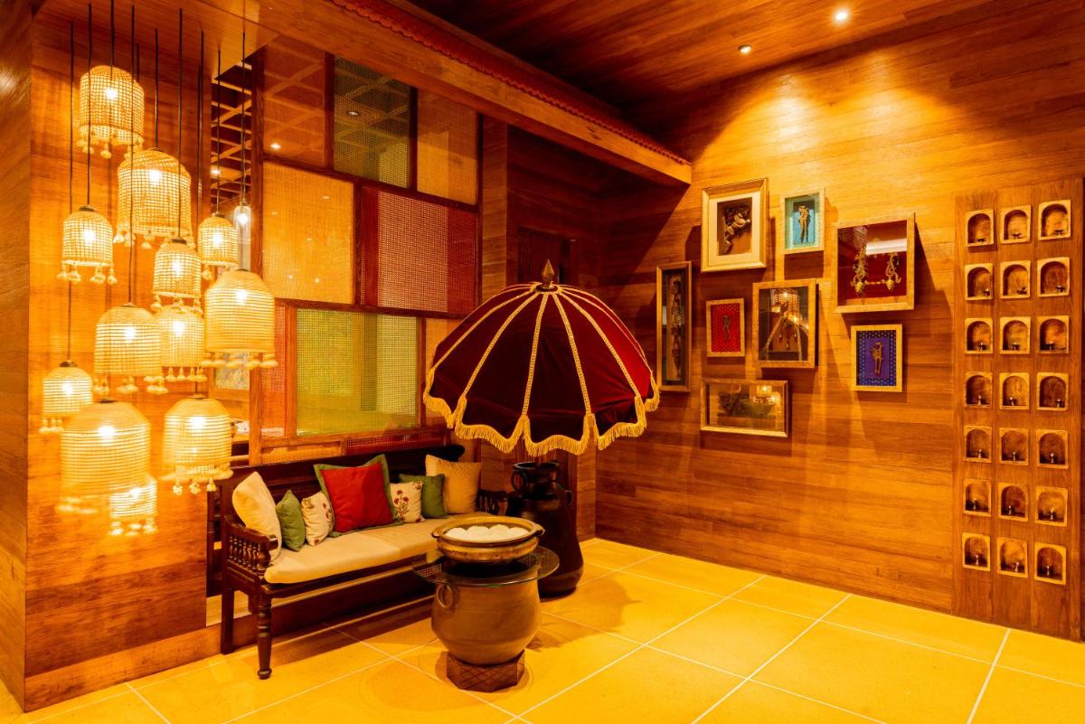 a living room with a bench and an umbrella at President - IHCL SeleQtions in Mumbai