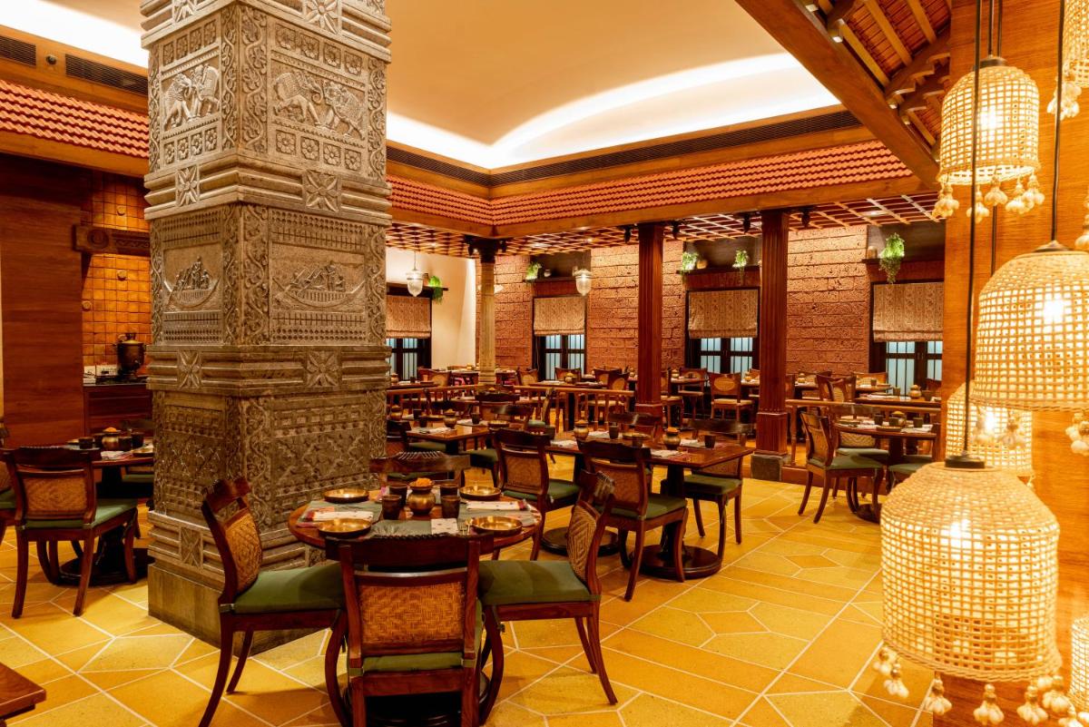 a restaurant with tables and chairs in a room at President - IHCL SeleQtions in Mumbai
