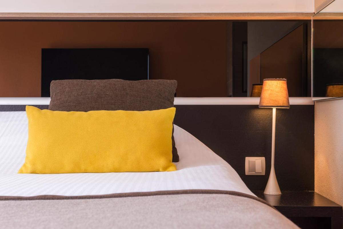 Un ou plusieurs lits dans un hébergement de l'établissement Hôtel Diana Restaurant & Spa by HappyCulture