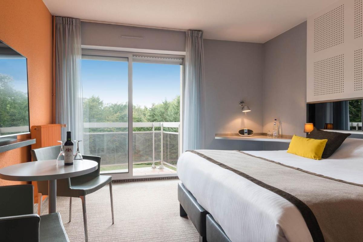 Un ou plusieurs lits dans un hébergement de l'établissement Hôtel Diana Restaurant & Spa by HappyCulture