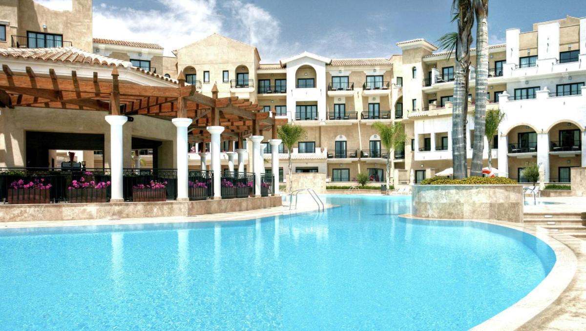 una gran piscina frente a un edificio en Doubletree By Hilton La Torre Golf Resort, en Roldán
