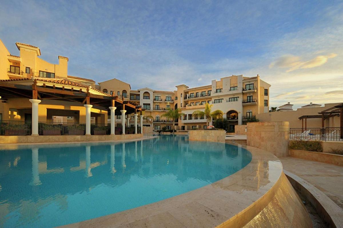 Una gran piscina frente a unos edificios. en Doubletree By Hilton La Torre Golf Resort, en Roldán