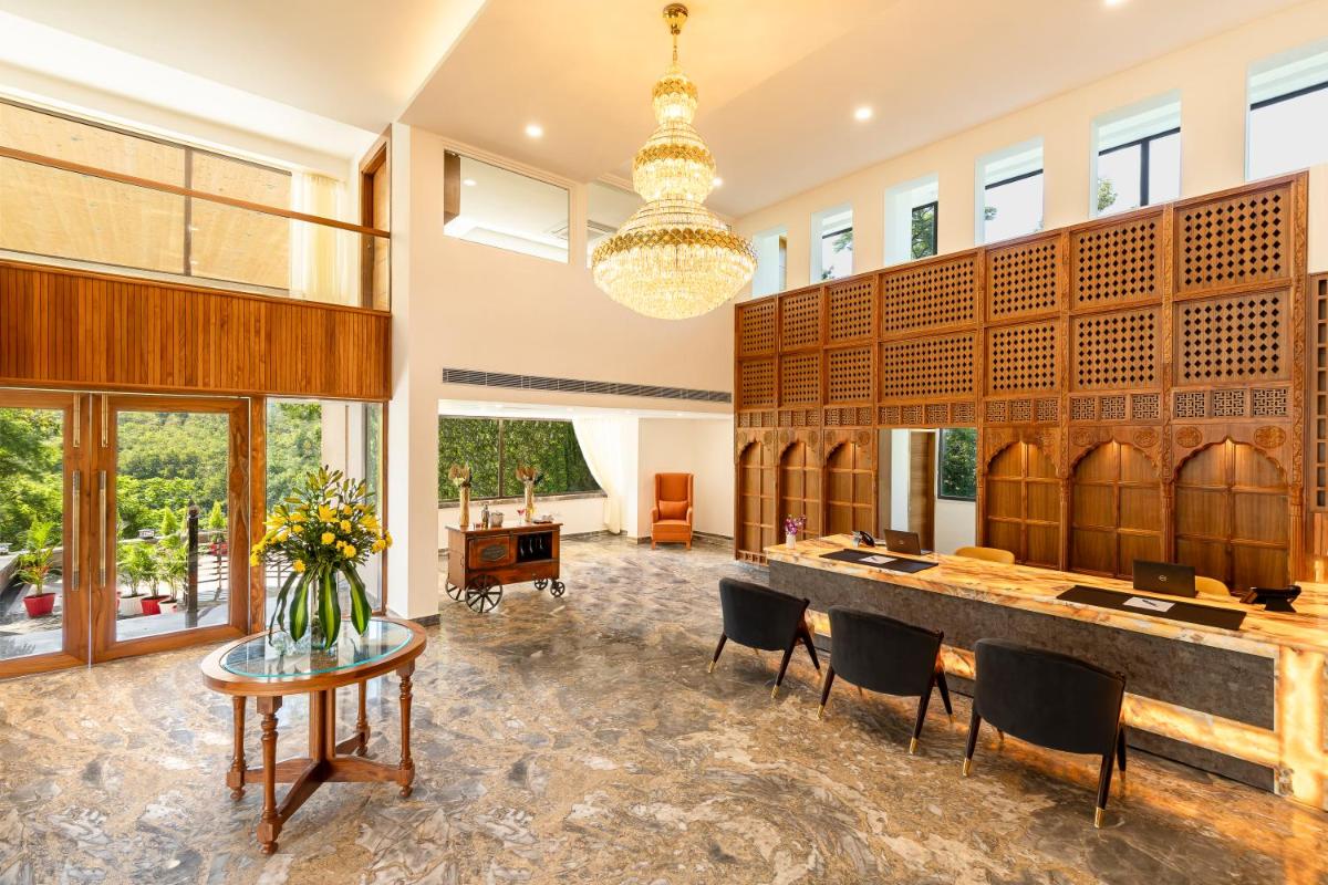 a large room with a table and chairs and a piano at The Prominence Mussoorie Road Dehradun in Dehradun