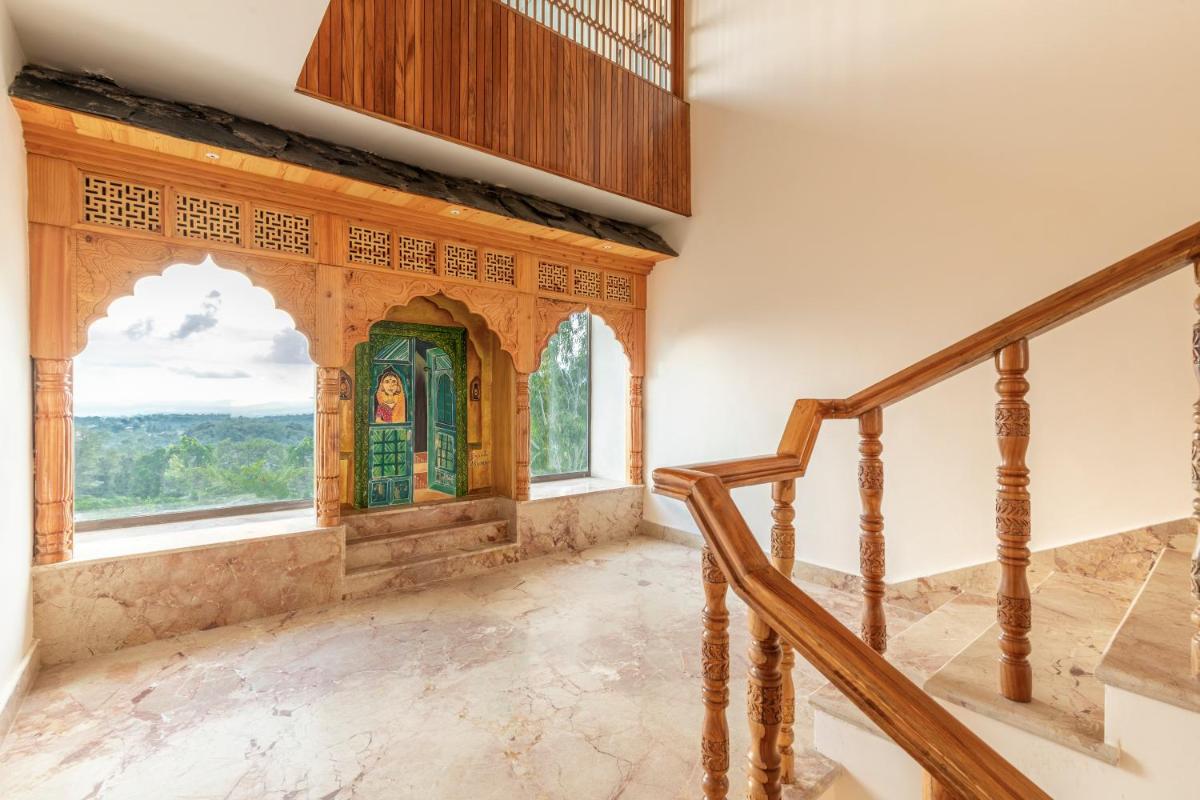 a staircase in a house with a window at The Prominence Mussoorie Road Dehradun in Dehradun