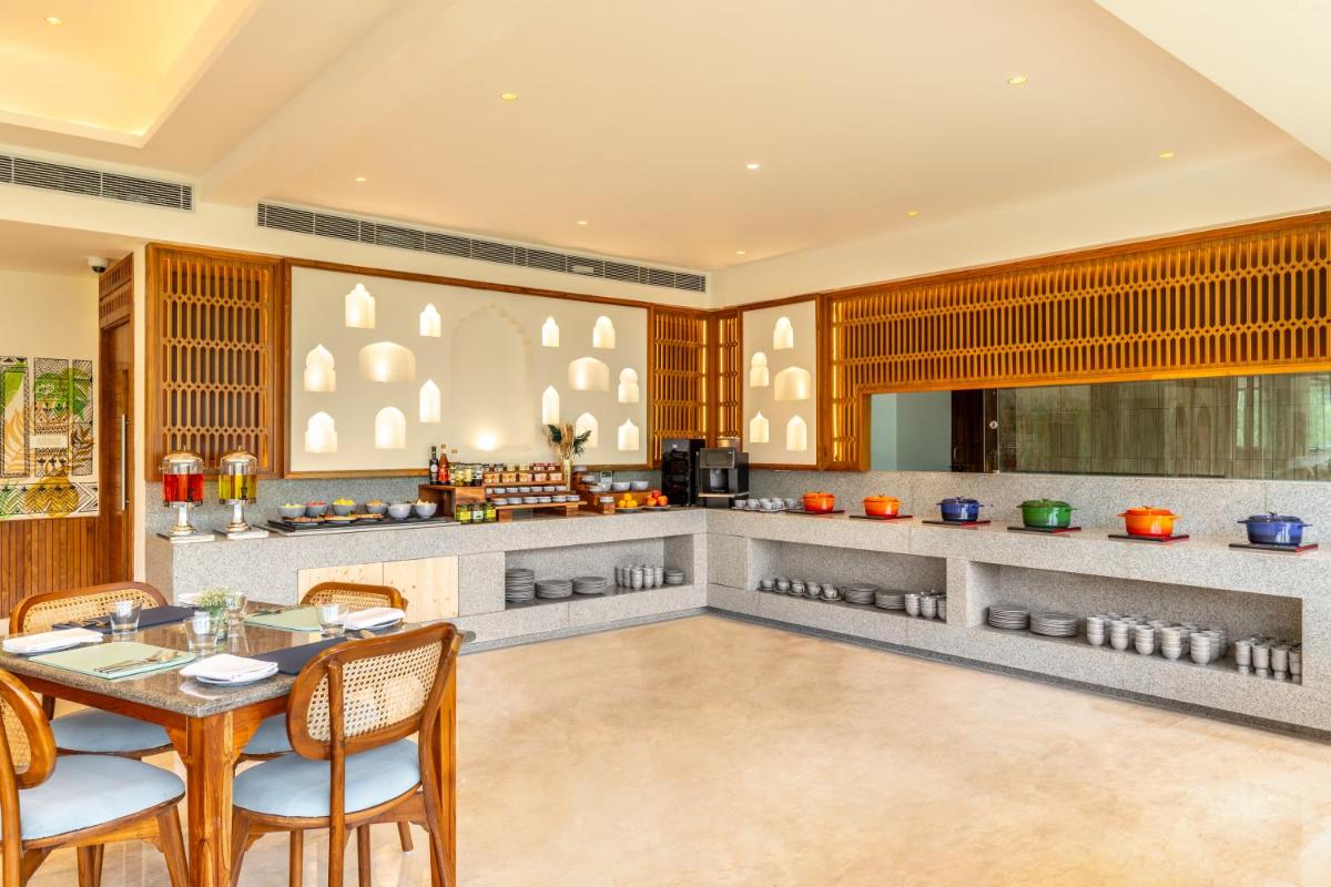 a kitchen with a table and chairs in a room at The Prominence Mussoorie Road Dehradun in Dehradun