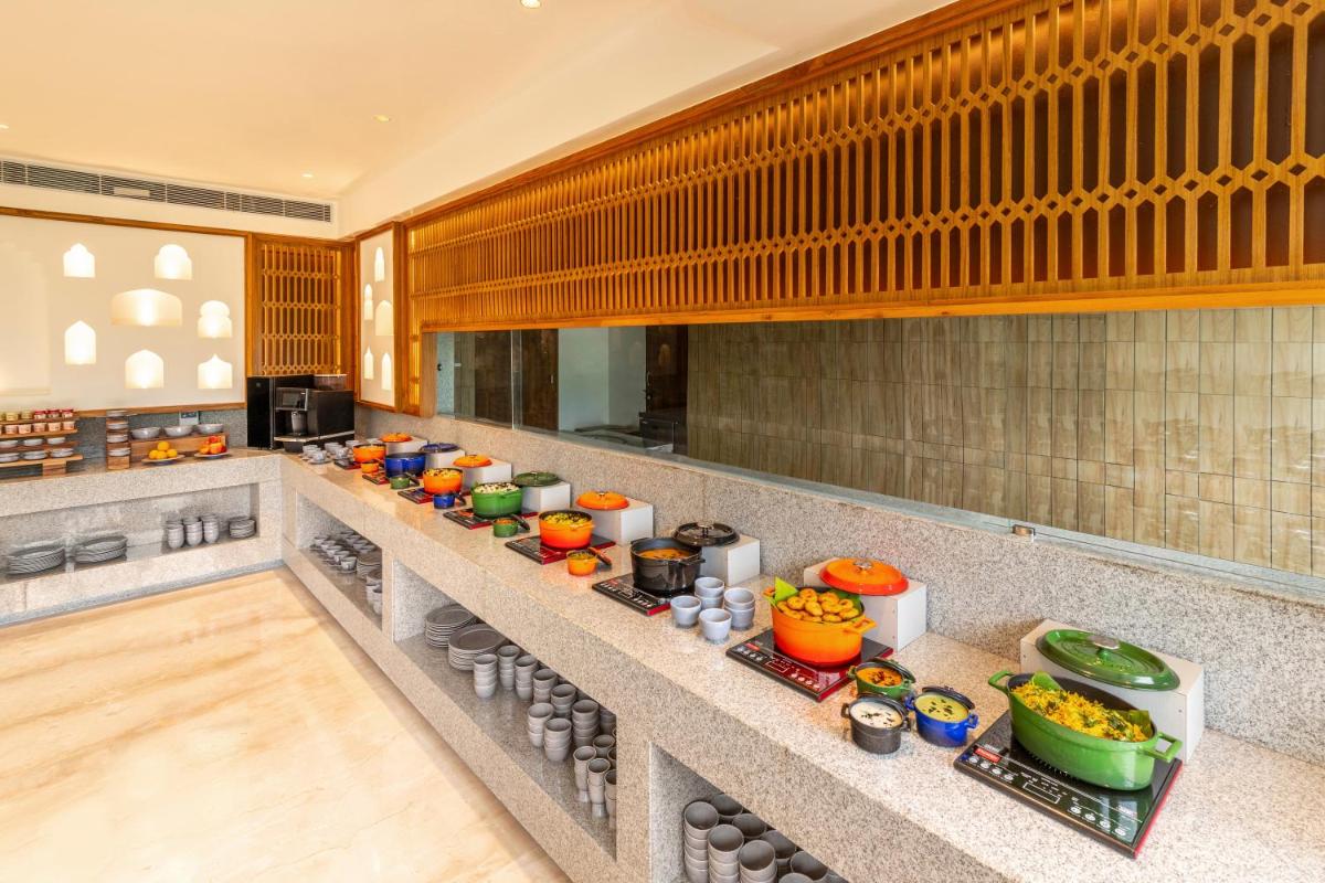 a kitchen with a bunch of food on a counter at The Prominence Mussoorie Road Dehradun in Dehradun