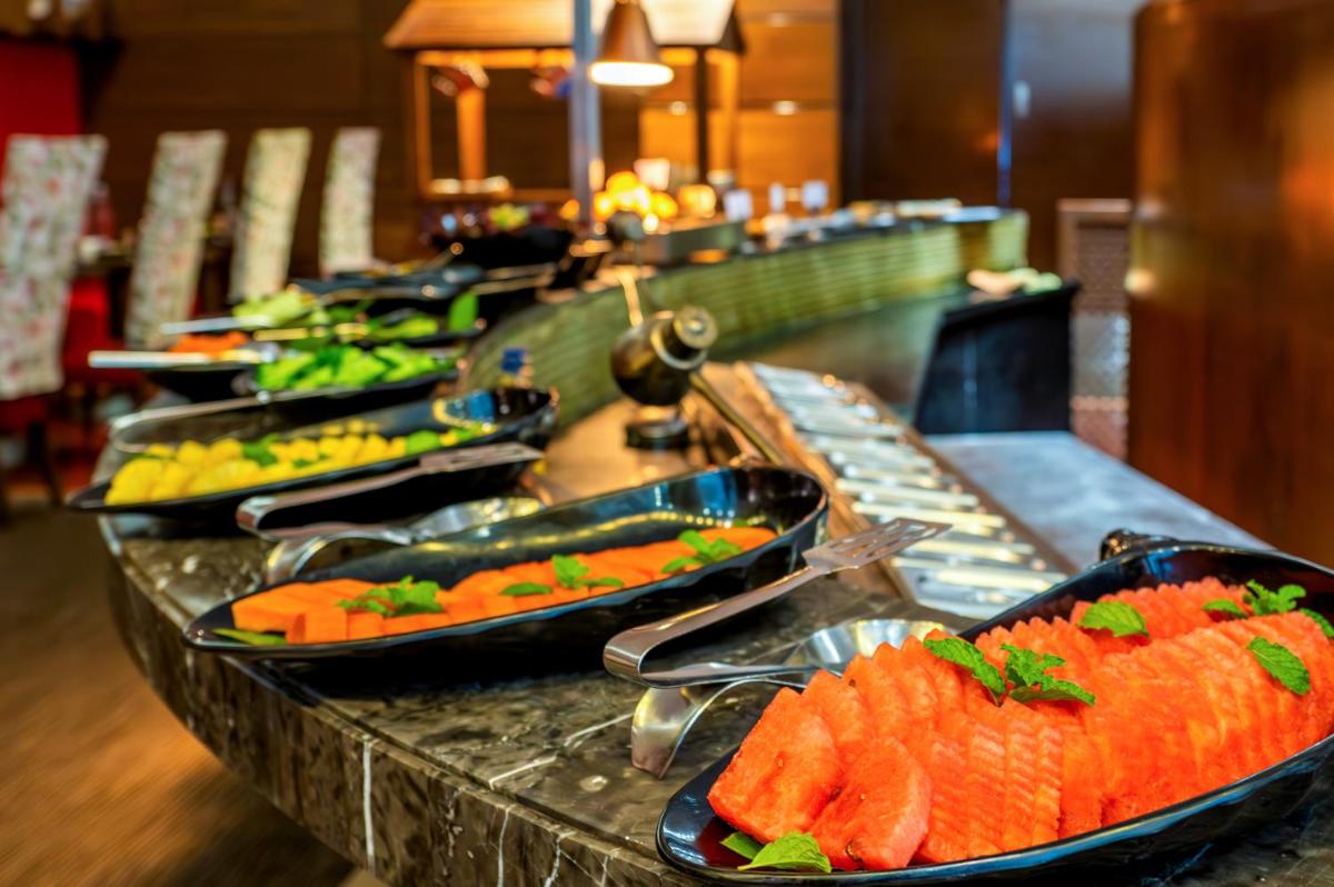 a buffet line with several plates of food at O Hotel Pune in Pune