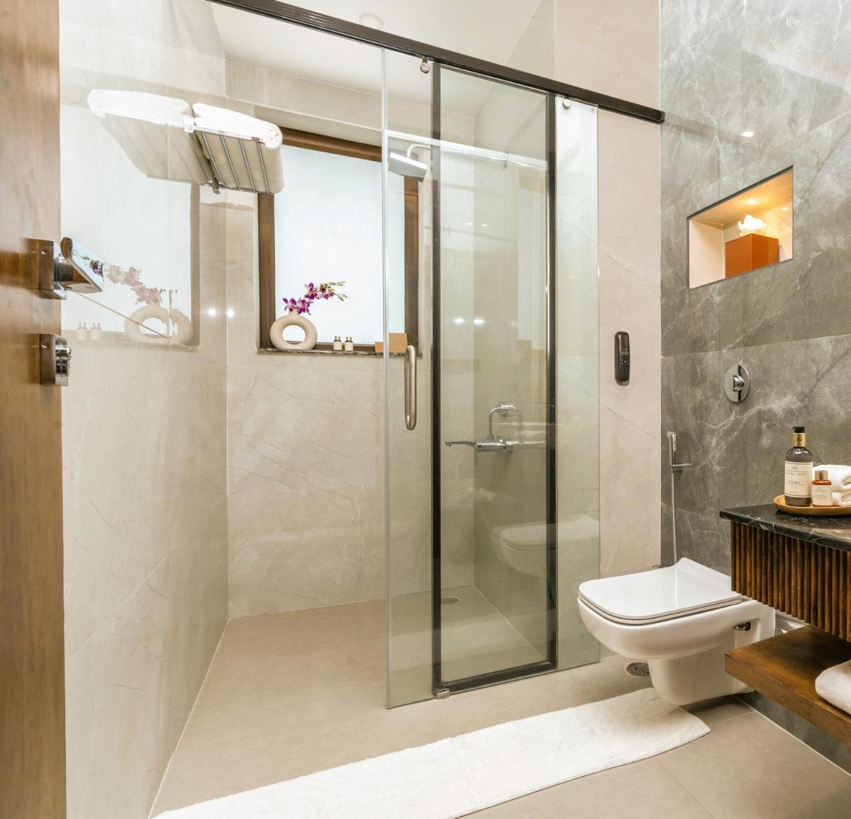 a bathroom with a shower and a toilet at ZANA Lakeview Resort - most scenic lakeside resort in Udaipur