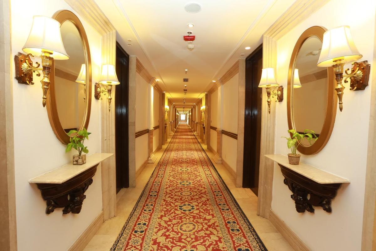a corridor of a hotel with mirrors and a rug at The Ashok, New Delhi in New Delhi a corridor of a hotel with mirrors and a rug at The Ashok, New Delhi in New Delhi