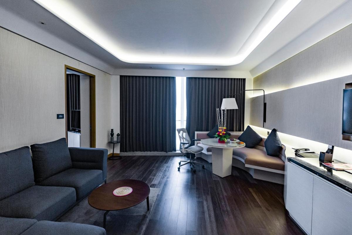 a living room with a couch and a table at DoubleTree by Hilton Ahmedabad in Ahmedabad